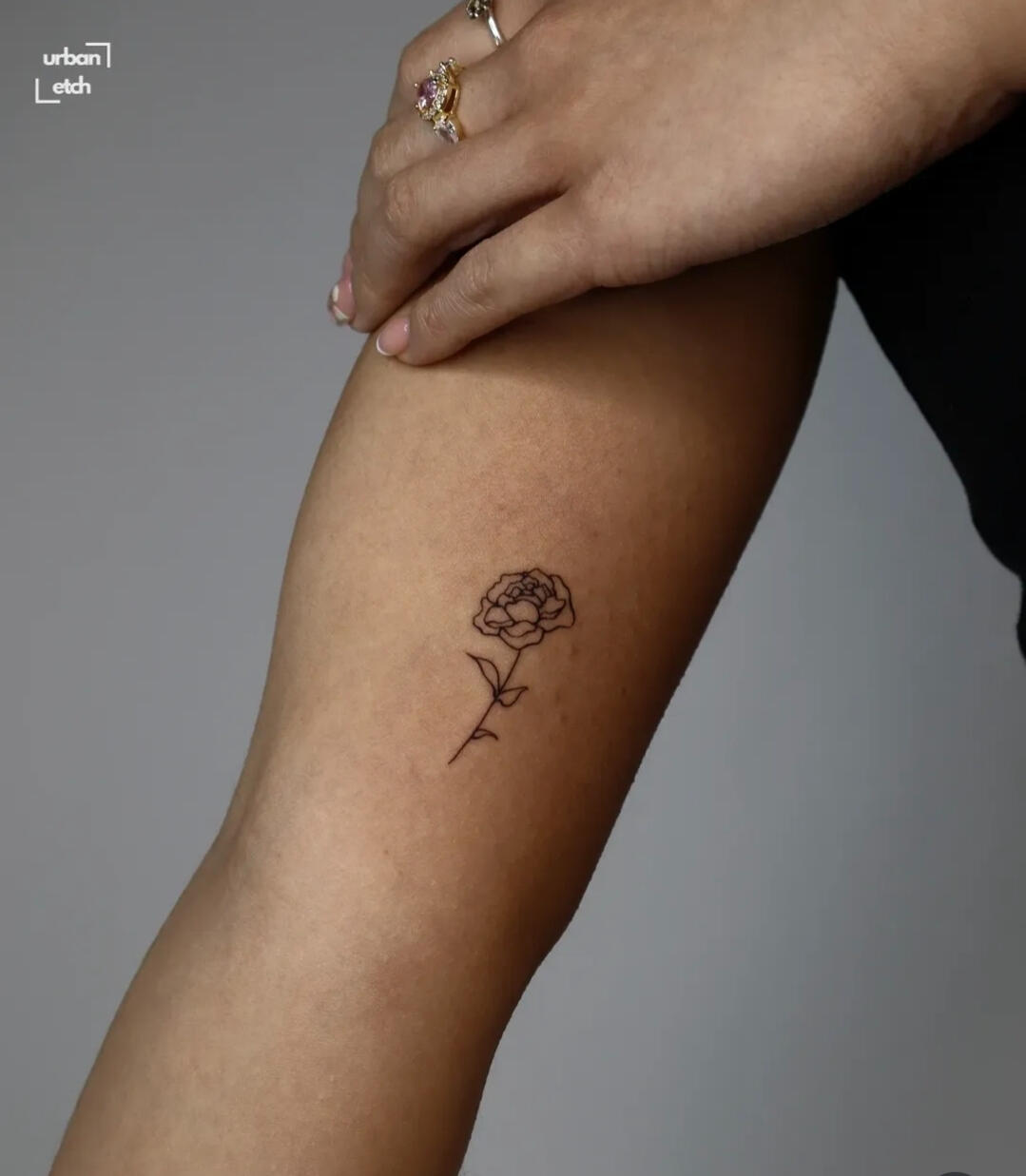 Fineline flower tattoo on inner arm